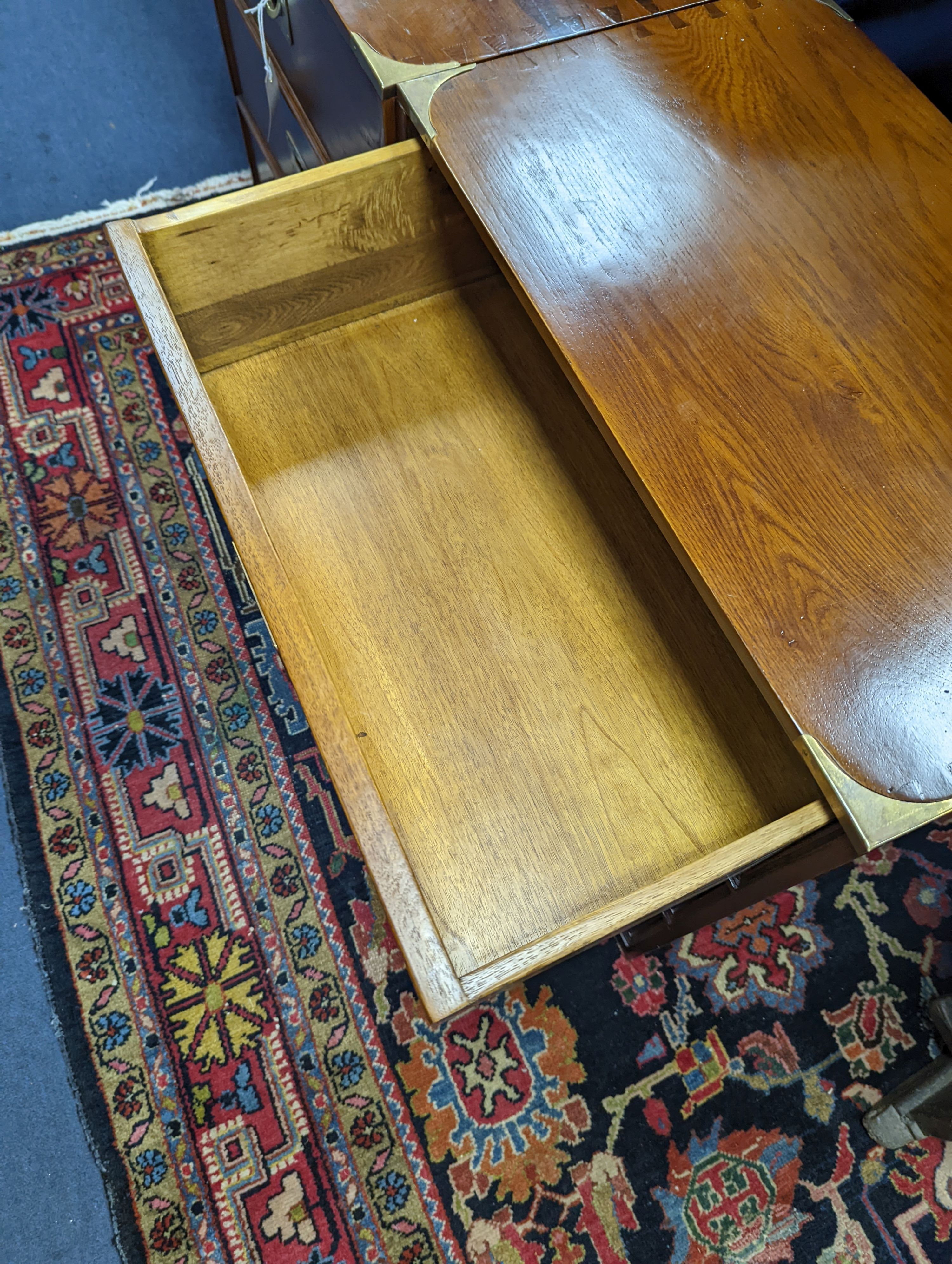 A pair of reproduction oak brass mounted military style bedside chests, width 58cm, depth 35cm, height 61cm